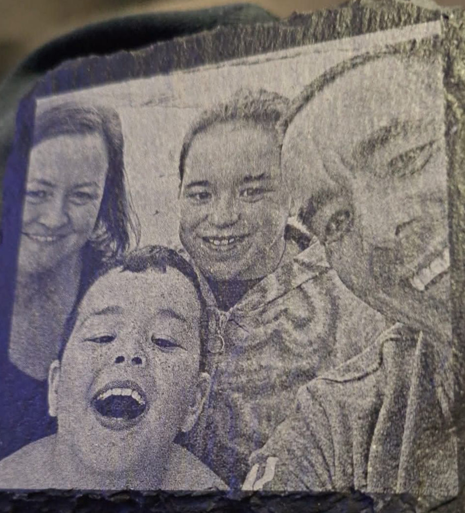 Close-up of a family photo engraved on a slate coaster